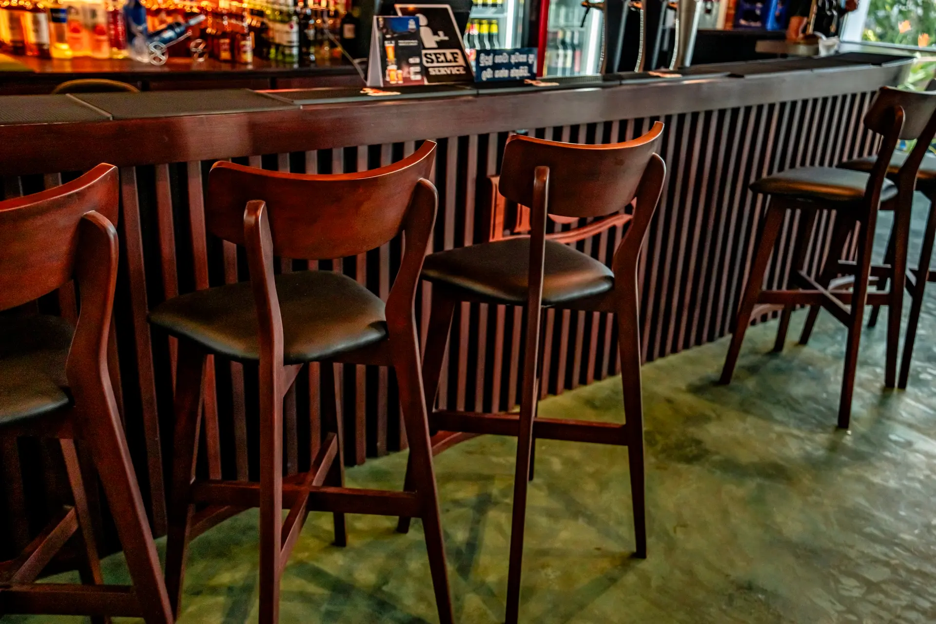 Bar stools along the wood-panelled counter