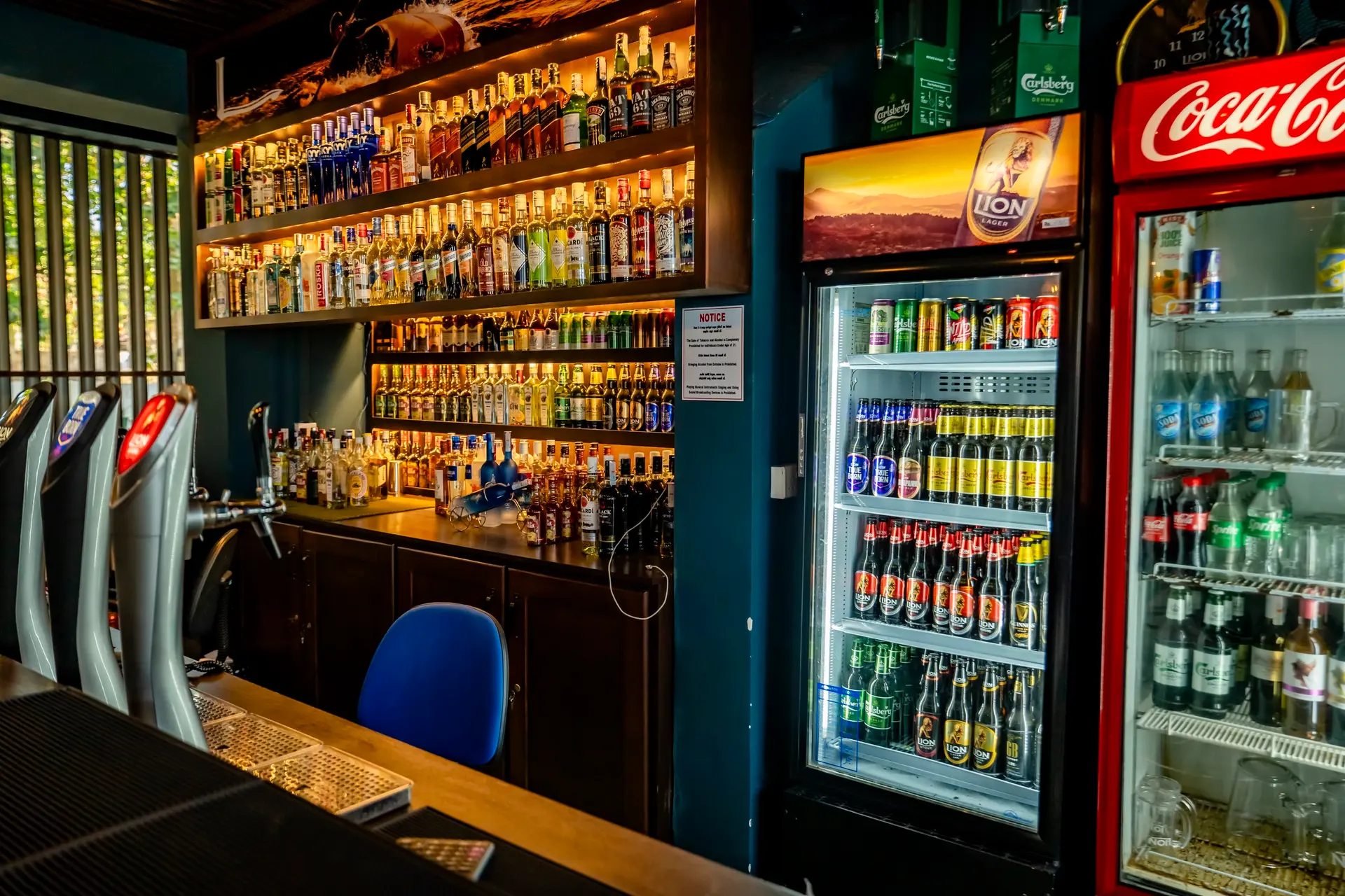 Bar counter with drinks fridge and shelves