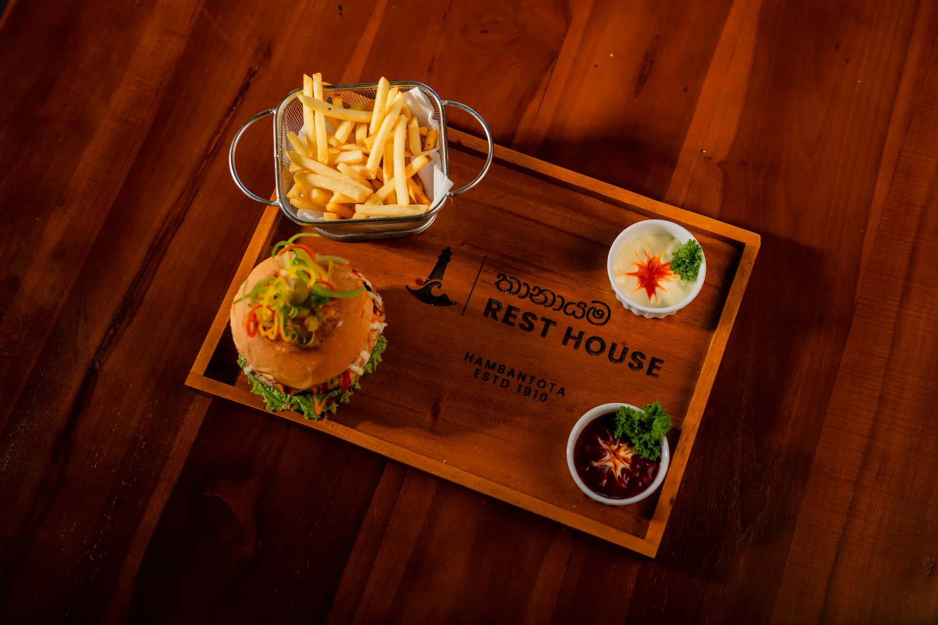 A burger and fries on a Rest House serving tray