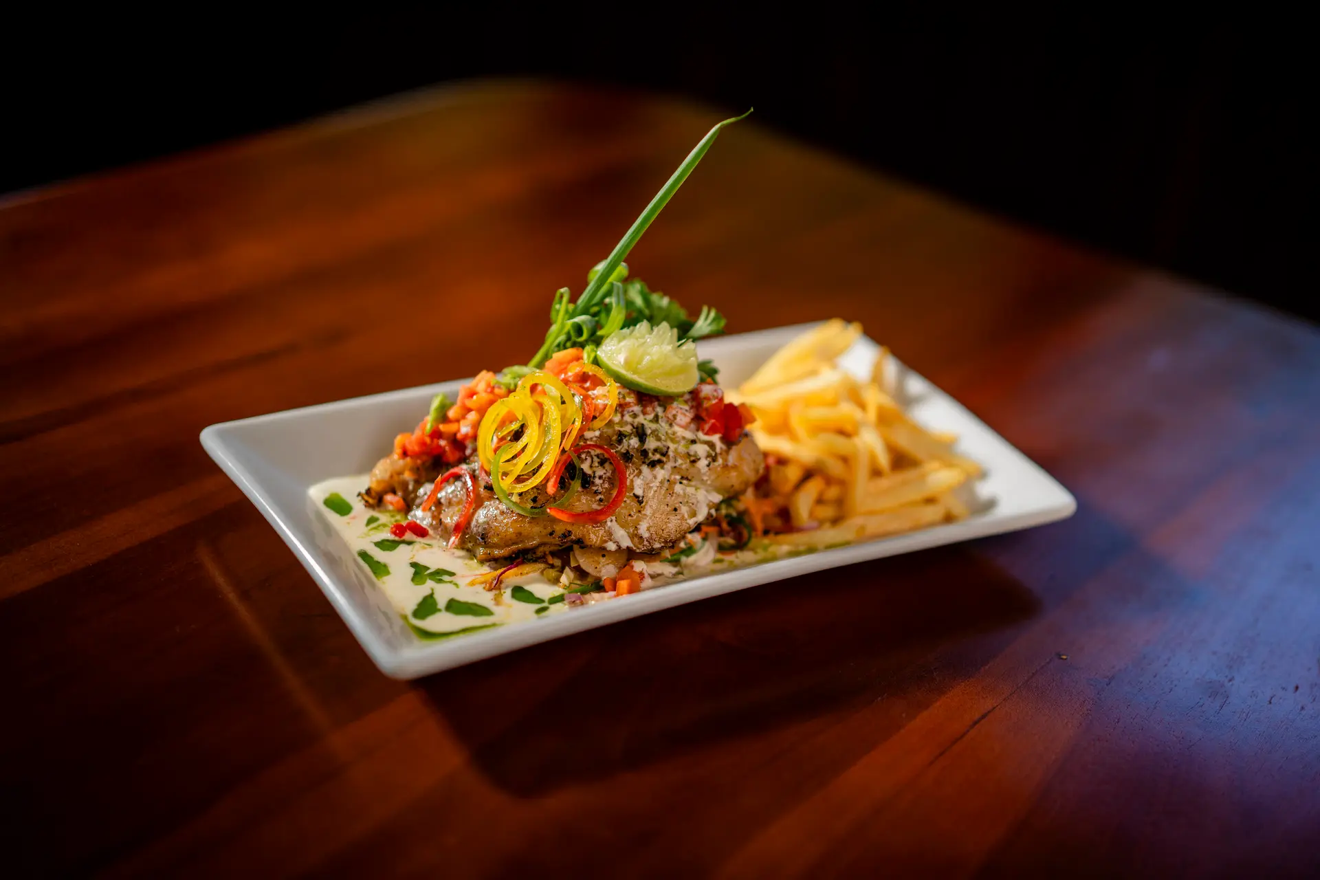 Grilled fish fillet with a cream sauce and fries