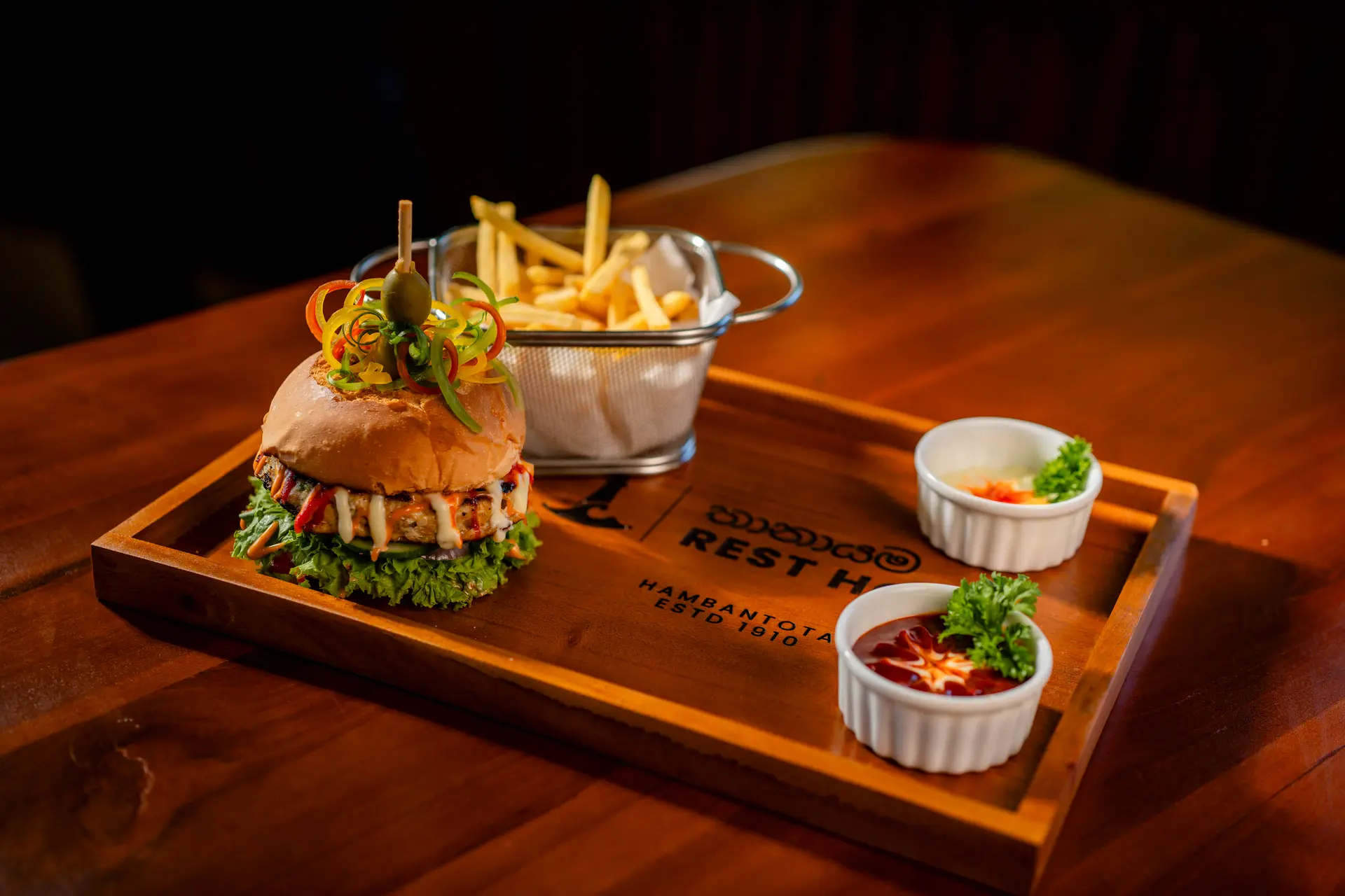 A burger, fries and dips on the Rest House tray