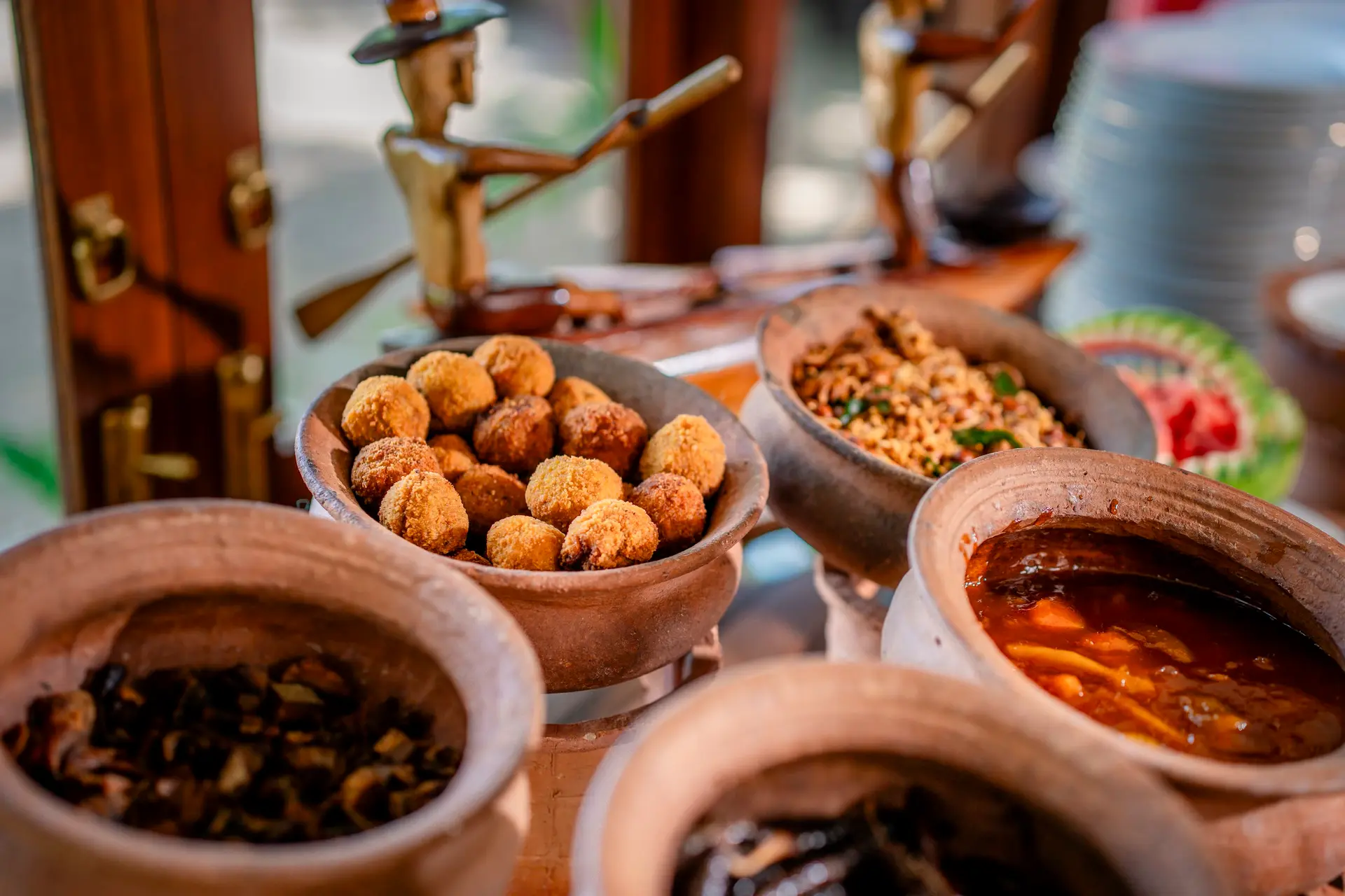 Fried snacks and curries in clay bowls