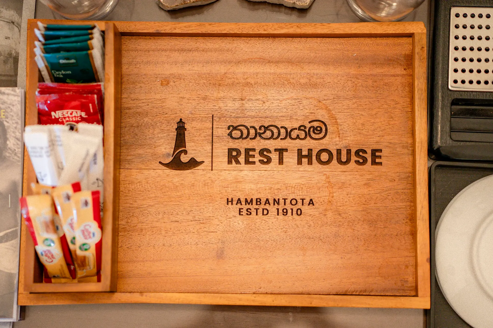 The Rest House crest on a teak tea tray