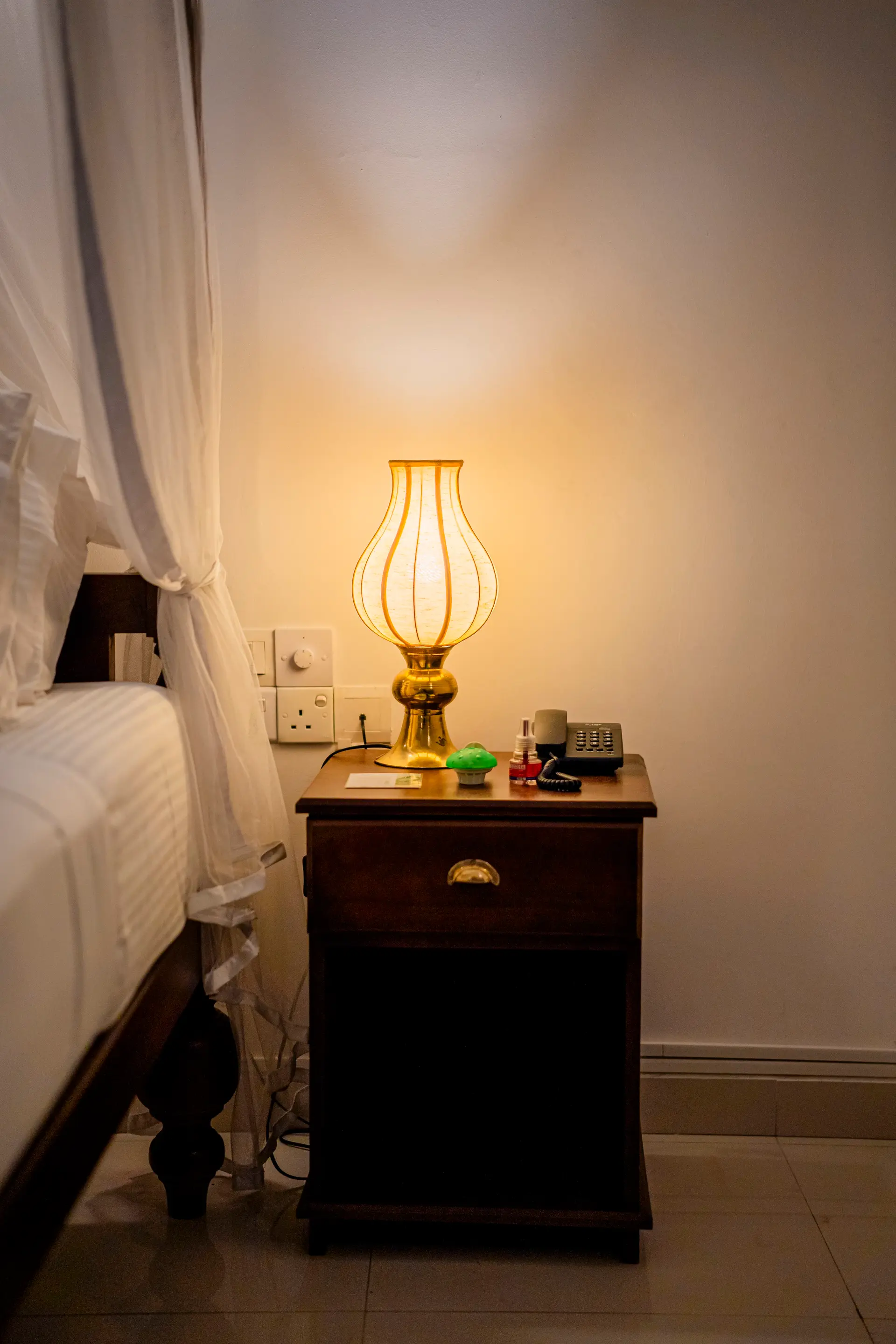 A bedside lamp in the evening