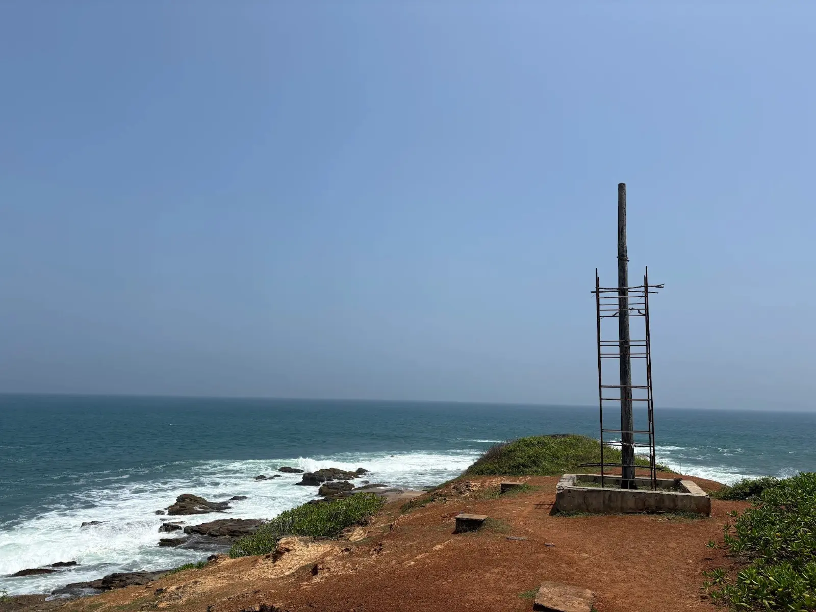 The gallows post on the red-earth headland, overlooking the sea