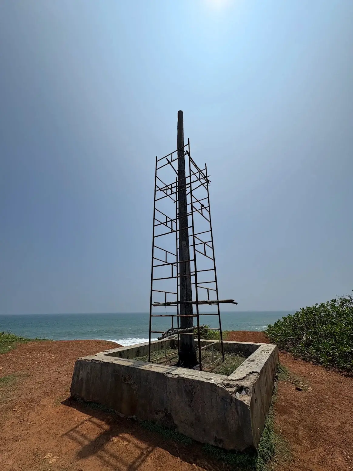 The gallows post and its iron frame against the sky